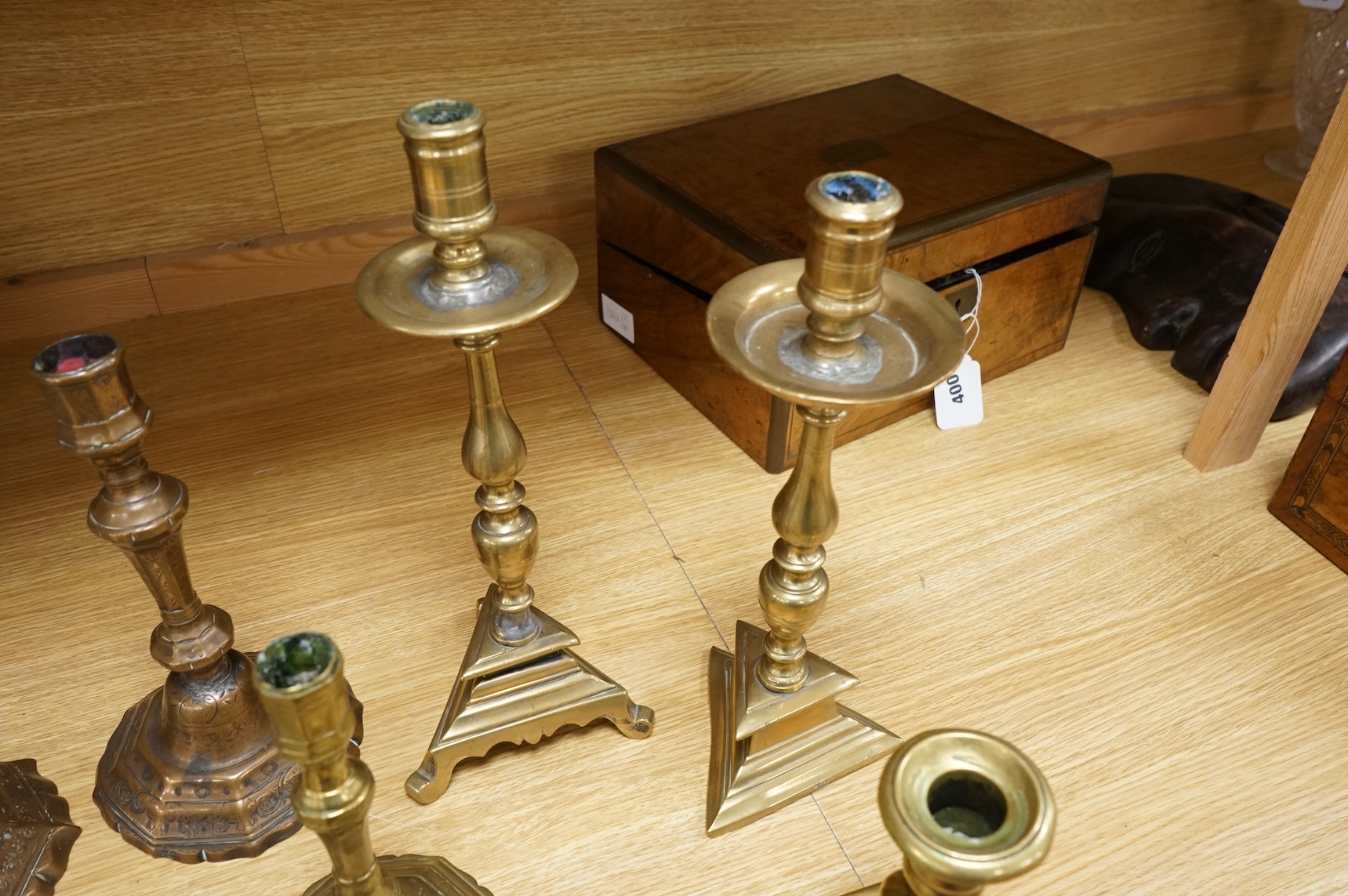 A group of period brass candlesticks, the majority 18th century